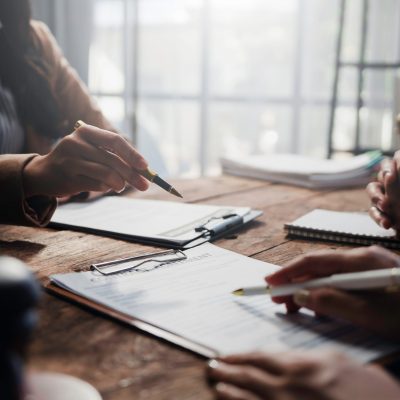 Lawyers and clients engaging in a detailed discussion about contract specifics during a focused meeting in a professional law office Lawyers and clients engaging in a detailed discussion about contract specifics during a focused meeting in a professional law office